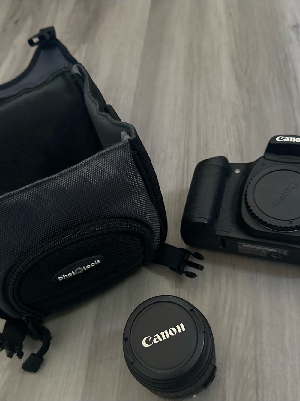 Canon Black DSLR Body with Black Lens Cap and Black Camera Pouch